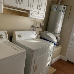 Utility room with washer, dryer, soft water